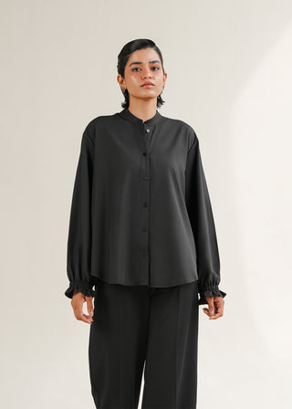 Ruffled Sleeve Shirt – WS25-186 for Women – Summer Reverie Collection | KOA | Shop Online.
Women wearing a black long-sleeve shirt and pants on a light background