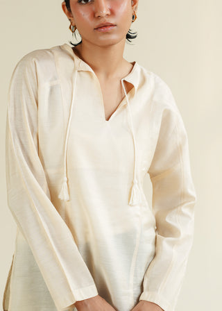Blouse with Panel Details – NW-04-A for Women – Summer Reverie Collection | KOA | Shop Online.
Women wearing a cream-colored shirt with long sleeves against a neutral background