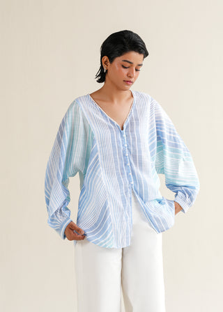 Striped Multi-colored Blouse – NW-05 for Women – Summer Reverie Collection | KOA | Shop Online.
Person wearing a light blue and white striped shirt against a beige background